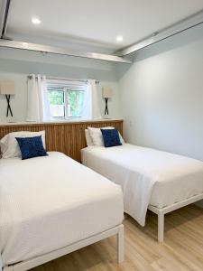 two beds sitting next to each other in a bedroom at Oasis by the Bay Vacation Suites in Wasaga Beach