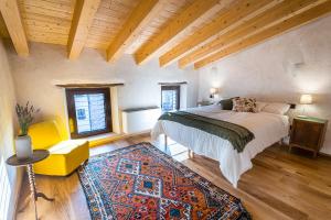 a bedroom with a large bed and a rug at Le Camere di Marietta in Rovere Veronese