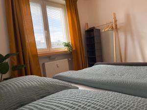 a bedroom with two beds and a window at Modern Oasis in the Heart of the City in Košice