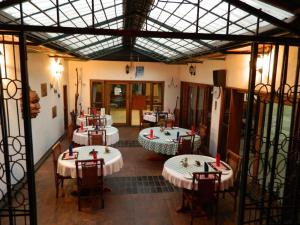 a room with tables and chairs in a building at The Landmark Boutique Hotel in Blantyre