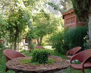 a wicker table and chairs in a garden at Royal Heritage Nagar in Maiūn