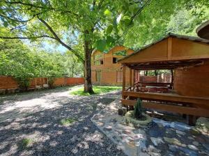 a dog house in a yard with a tree at Villa Maxi Likani in Likani +14 photos