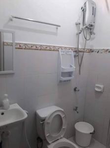 a white bathroom with a toilet and a sink at FOMAG House GenSan 2BR in General Santos