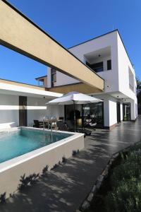 a house with a swimming pool in front of it at Neptunia - 4 bedroom villa in Medulin