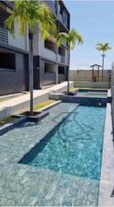 The swimming pool at or close to Cobertura Vista Mar Carapibus - Cariri Praia - Apartamento completo com 02 quartos