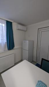 a small room with a refrigerator and a window at White Orchid in Mtskheta