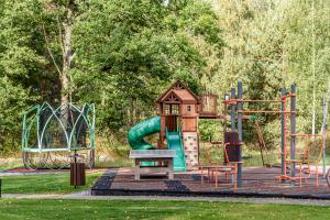 a playground with a slide in a park at Paplūdimio namukas in Molėtai