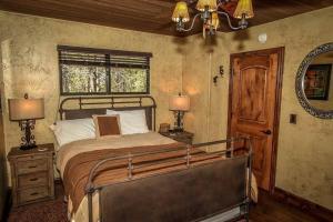 a bedroom with a bed and two lamps and a window at How Sweet It Is~ Downtown Village Retreat Cabin~ Walk to Marinas and Shopping in Big Bear Lake