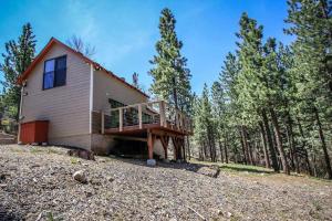 a house with a deck in the woods at How Sweet It Is~ Downtown Village Retreat Cabin~ Walk to Marinas and Shopping in Big Bear Lake