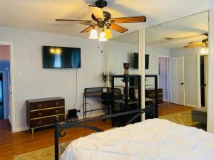 a bedroom with a bed and a ceiling fan at San Antonio Comfort 4 Bedroom 3 Bath home 5 Mins from Sea World in San Antonio
