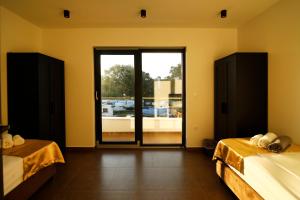 a bedroom with two beds and a large window at Neptunia - 4 bedroom villa in Medulin