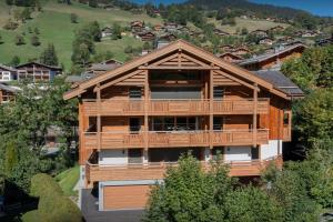 an aerial view of a large wooden house with a balcony at Le Grand Bossonnet - OVO Network in La Clusaz