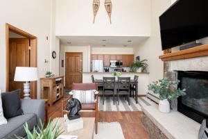 a living room with a couch and a fireplace at Mountain Views Galore - Avon Condo - Walk to Town in Avon