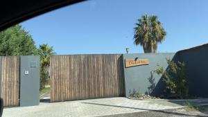 a wooden fence with a sign on it at Chalé do Vale in Pinhal Novo