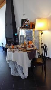 a dining room table with a white table cloth on it at La Luna nel Borgo in Brugnato