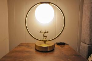 a lamp on a table with a round mirror on it at Ursa Major- Ultra Modern Resort Duplex- in Big Bear Lake