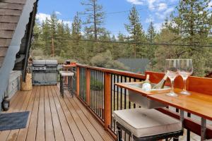 a deck with a table with wine glasses on it at Ursa Major- Ultra Modern Resort Duplex- in Big Bear Lake
