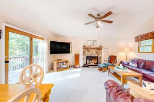 a living room with a couch and a fireplace at Sandy Beech in Beech Mountain