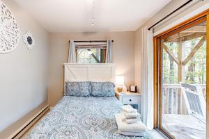 a small bedroom with a bed and a window at Sandy Beech in Beech Mountain
