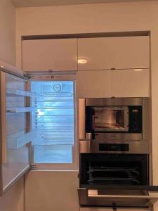 a kitchen with a microwave and a window at Stylish 2 Bedrooms Condo w/ awesome View & Parking in Toronto