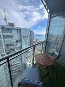 a balcony with a desk and a chair on a building at Stylish 2 Bedrooms Condo w/ awesome View & Parking in Toronto