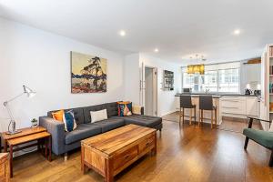 a living room with a couch and a table at Blackfriars Printhouse Retreat in London