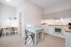a kitchen with a table and a table and chairs at Zaunkönig Apartments in Baden-Baden