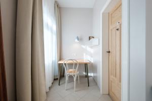 a small table with a chair next to a window at Zaunkönig Apartments in Baden-Baden