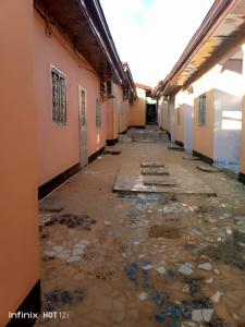 an empty hallway of a building with trash on the ground at EDISON CITY PALACE GUEST HOME in Bertoua