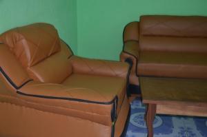 a living room with a couch and a chair at EDISON CITY PALACE GUEST HOME in Bertoua