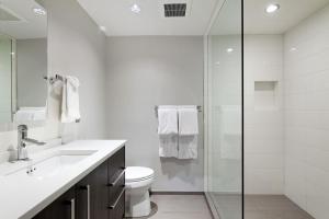 a bathroom with a toilet and a glass shower at Alpenblick 10, Three level Townhome, Two Block From the Gondola in Aspen +8 photos