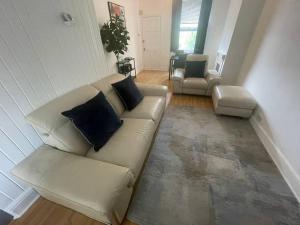 a living room with a couch and two chairs at 3 Bedroom House in Dartford in Kent