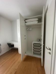 a white closet with a white door and a desk at Thyke Apartment in Krapinske Toplice