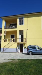 a car parked in front of a yellow building at Casa Vacanze Matilde in La Spezia