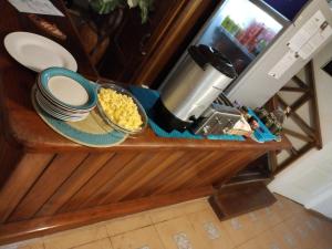 a counter with plates and bowls of food on it at Hotel Tierra Verde in Bocas del Toro