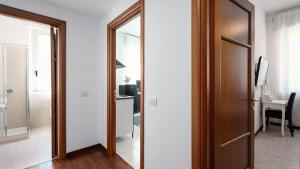 a hallway with a door and a room with a desk at Blue City Paradise - Renovated APT in center Milan in Milan