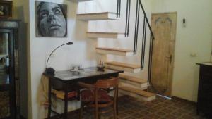 a room with a table with chairs and stairs at Sotto il carrubo in Sciacca