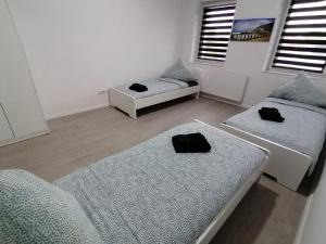 a living room with two beds and two windows at estrella24 LIVING ROOMS Tokio in Herne