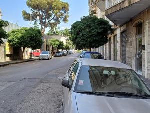 a silver car parked on the side of a street at Costa del Sole in Salerno