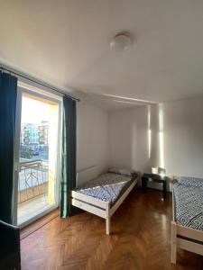 a bedroom with a bed and a large window at Apartament Celna in Nysa