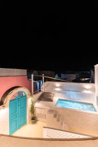 a house with a swimming pool with a door at Marla Luxury Residences in Megalochori