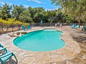 a swimming pool with chairs and a patio at Canyon Lake Cabins in Canyon Lake