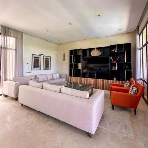 a large living room with two couches and a tv at Al Destino Villa Riad Spa Luxury Marrakech in Marrakech