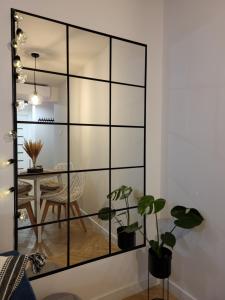 a room with a large glass partition with plants at MoreLove I in Sandomierz +9 photos