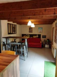 a living room with a red couch and chairs at Maison familiale Nantes Sud in Bouguenais