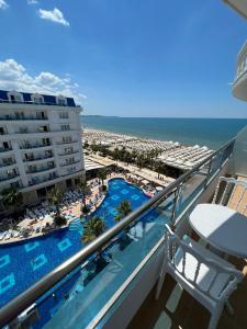 a balcony with a view of a pool and a beach at Alb's Apartment 2 in Golem