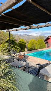 a patio with chairs and a swimming pool at cabañas altos de giardino in Villa Giardino