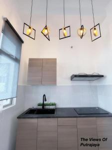 a kitchen with a sink and lights on the wall at View of Putrajaya in Putrajaya
