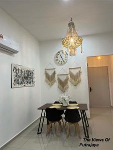 a dining room with a table and a clock on the wall at View of Putrajaya in Putrajaya