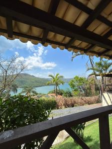 a view of a lake from the porch of a house at Mirante do Lago in Capitólio